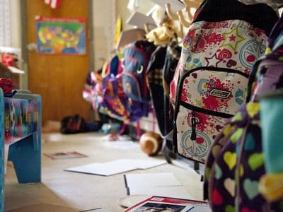black yellow and red backpack on white table